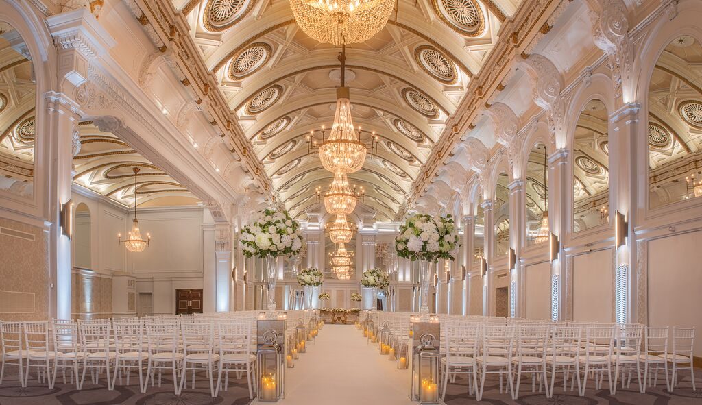 Ceremony set in the Grand Hall at the Grand Connaught Rooms, chandeliers and barrel vaulted ceiling